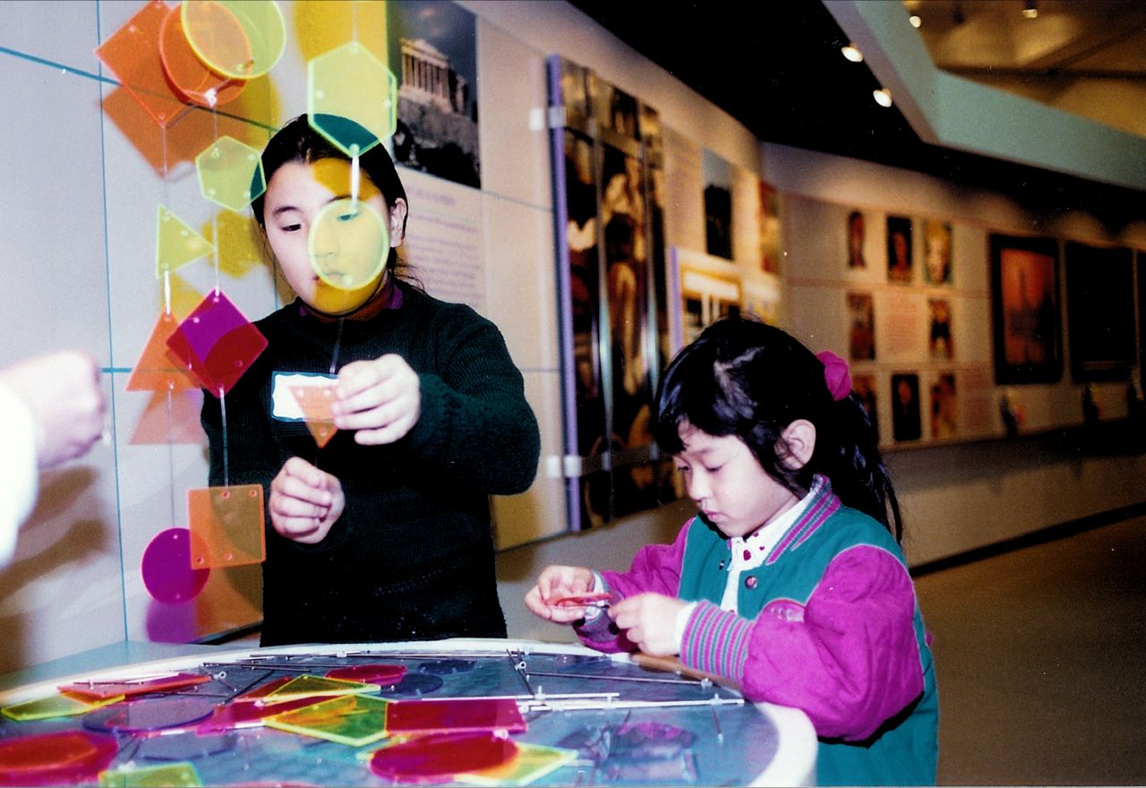 Fashioning a mobile with a friend offers hands-on social experience with balance and composition.